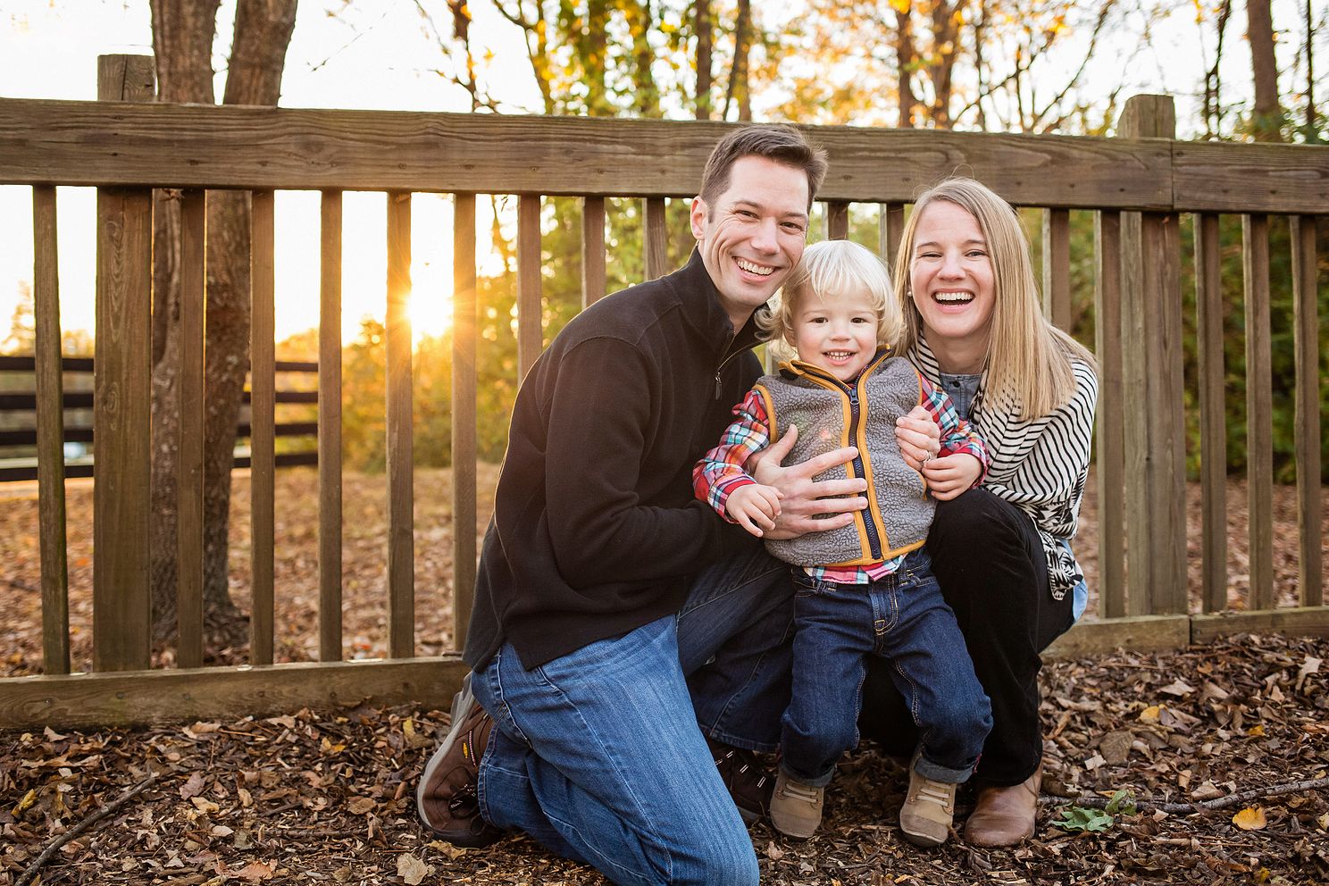 Family smiles at camera on playground during Golden hour in Nashville