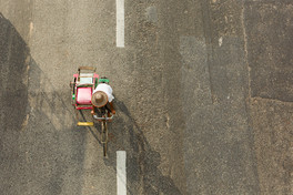 A bicycle taxi passed under a bridge