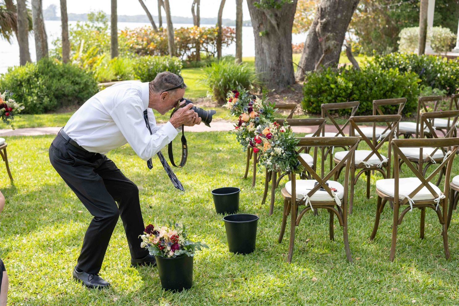 Mike photographs flowers lining the aisle before wedding at Bay Preserve at Osprey