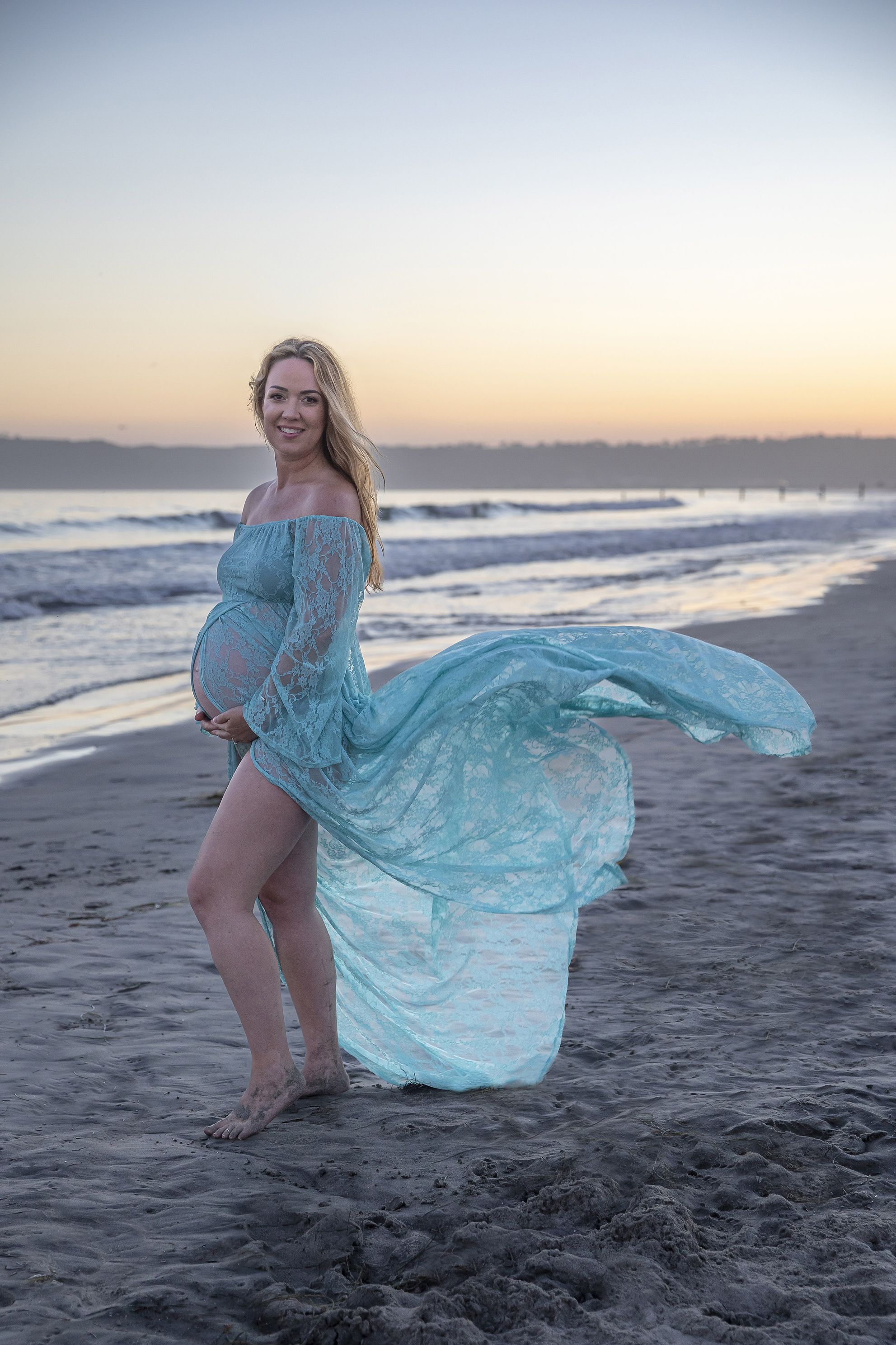 Aqua maternity dress at sunset, dress toss, beach maternity shoot 37 weeks. Accredited Photographer