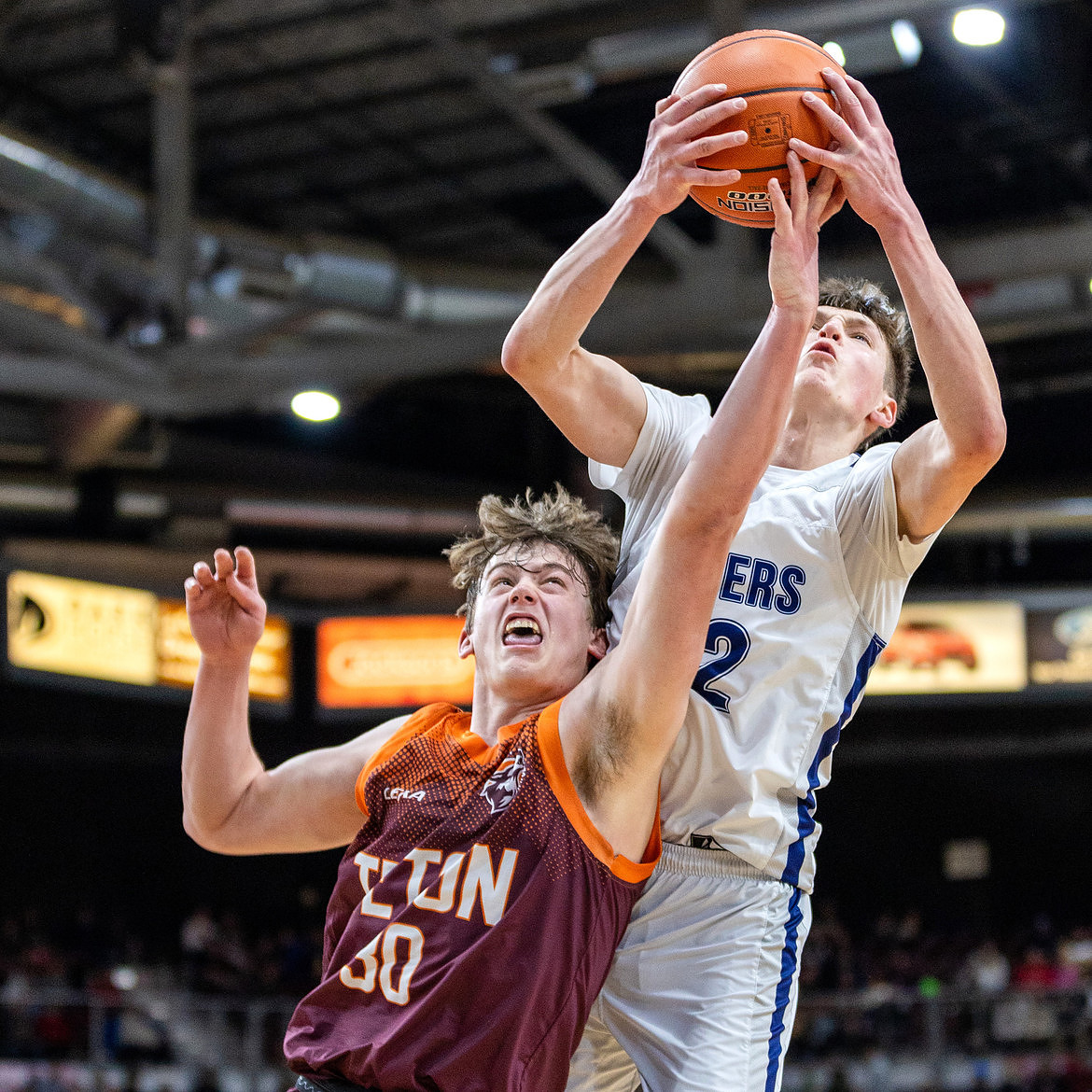Bonners Ferry junior Asher Williams fights Teton senior Tyson Brown for possession of a rebound Thur