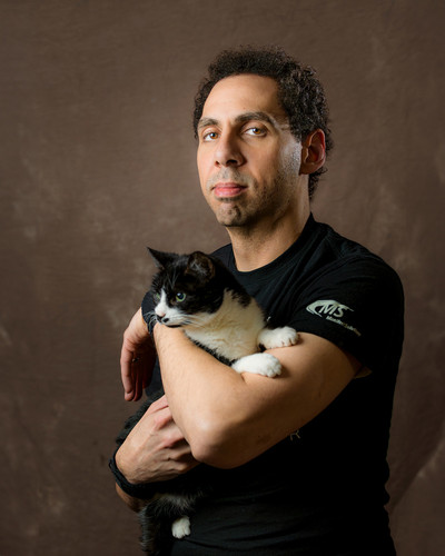 Pet photography featuring man posing with his tuxedo cat by Akron photographer Mara Robinson