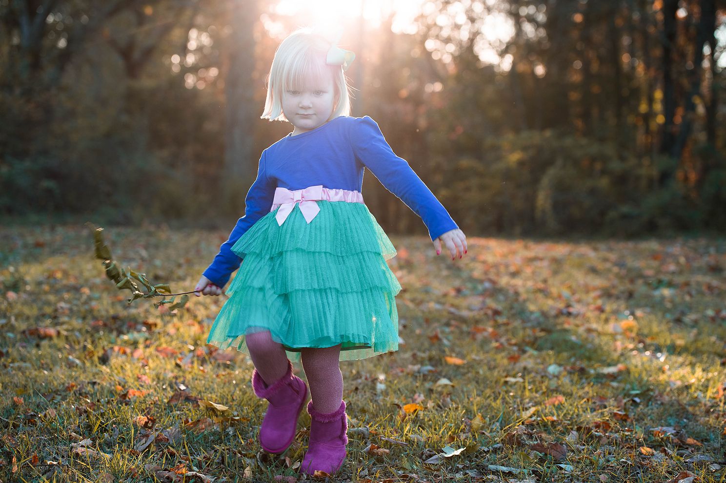 little girl walking with son shining behind her