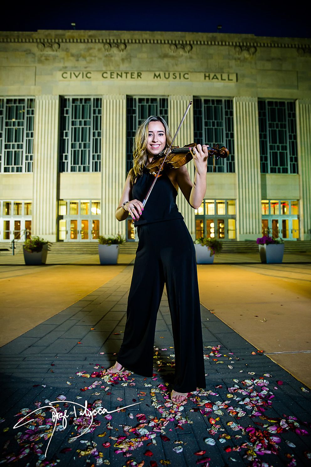 Oklahoma Senior girl playing violin at night in front of civic center music hall
