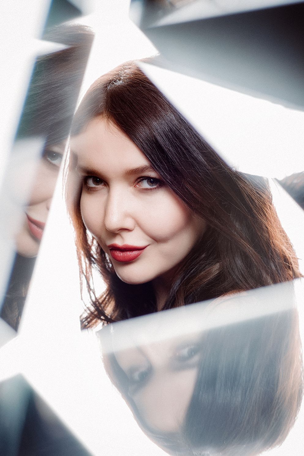 portrait of a female model shot through a prism reflecting multiple images of her face