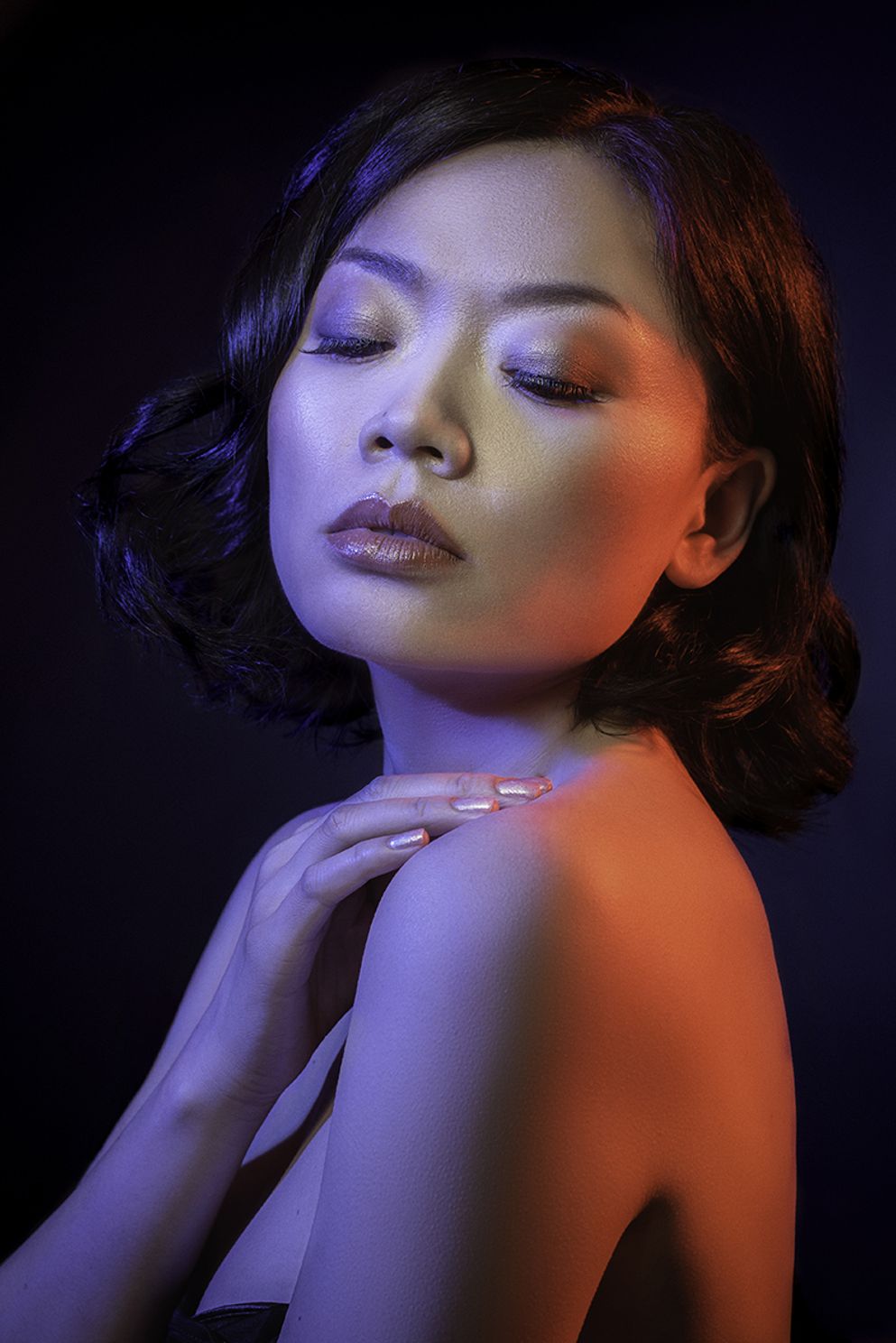 sophisticated portrait of an Asian female model using red and blue colored gels