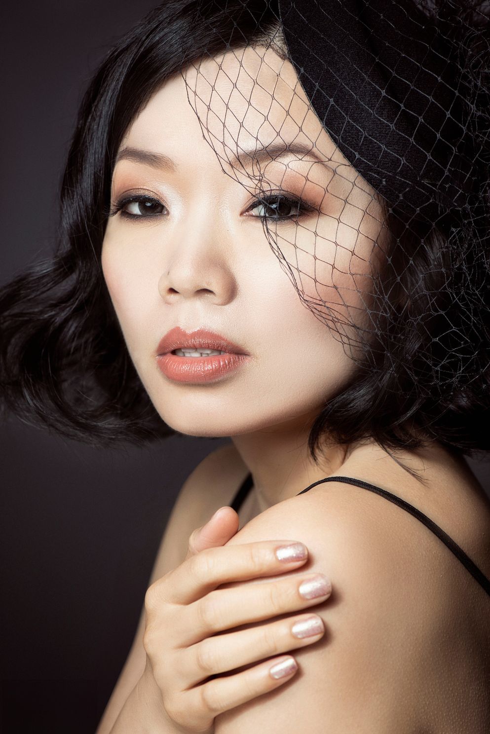 Close-up image of an elegant Asian female model with a net on her head