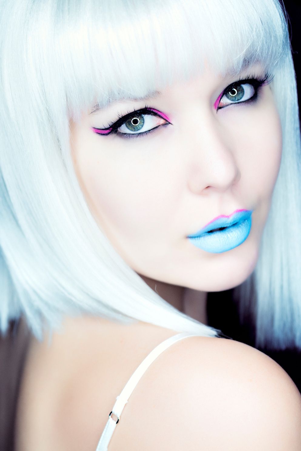 electrifying capture of a striking white-blond female in blue lipstick looking back over shoulder