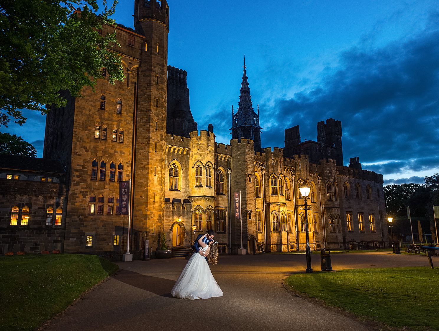 Wedding photographer Peter Morgan with a wedding couple at Cardiff castle in front of Castle.