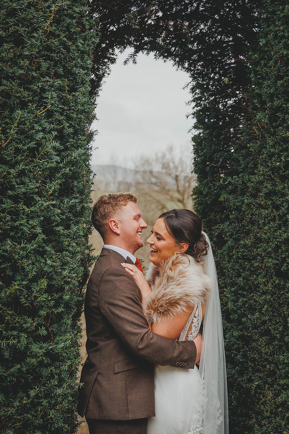 Wedding couple in the trees at Peterstone Court photographed by Peter Morgan