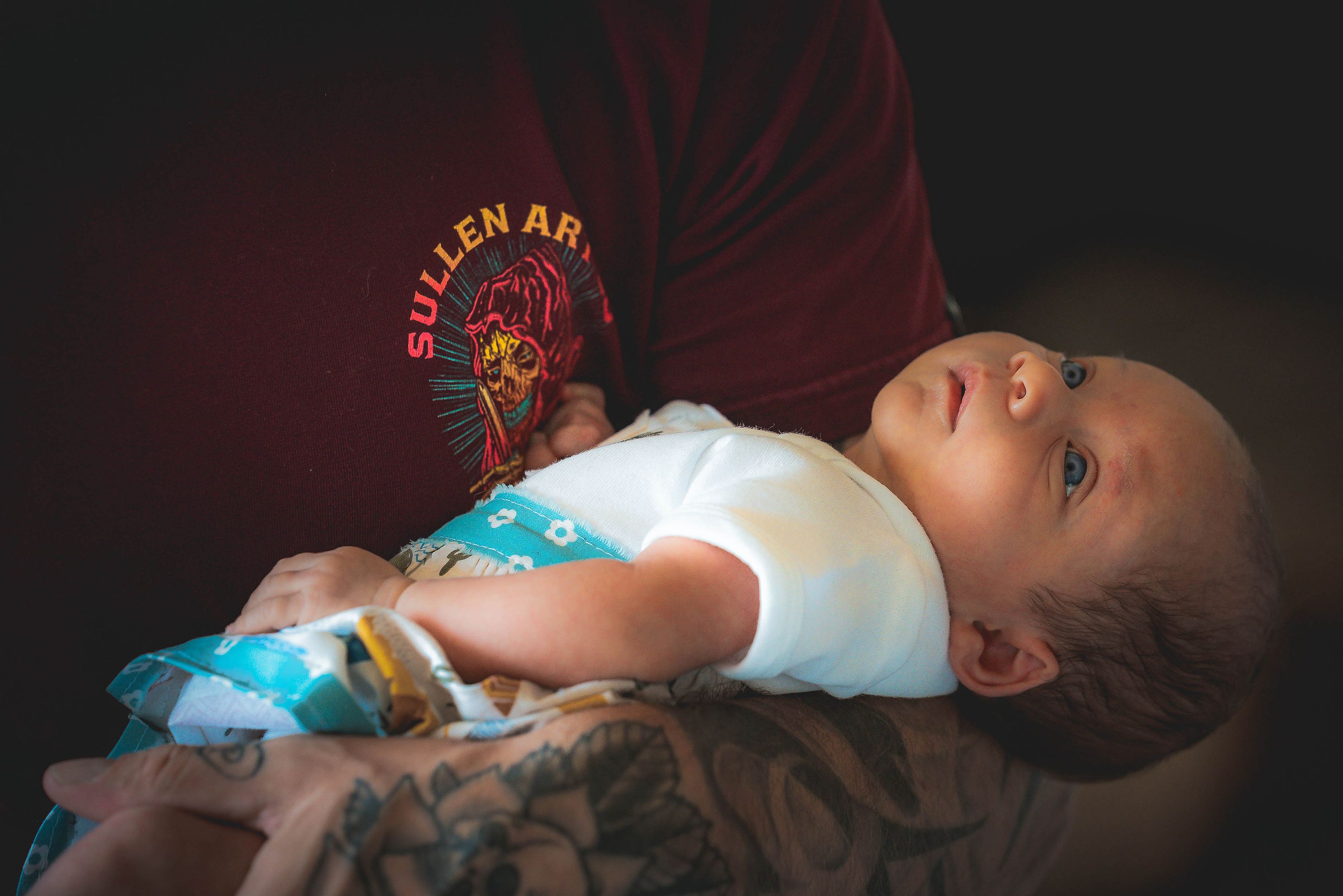 A closeup of a father holding a baby