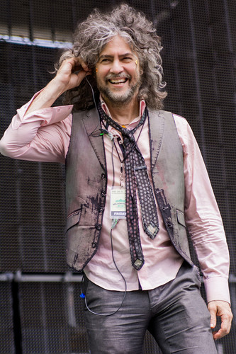Concert portrait photography featuring Wayne Coyne of The Flaming Lips smiling at audience