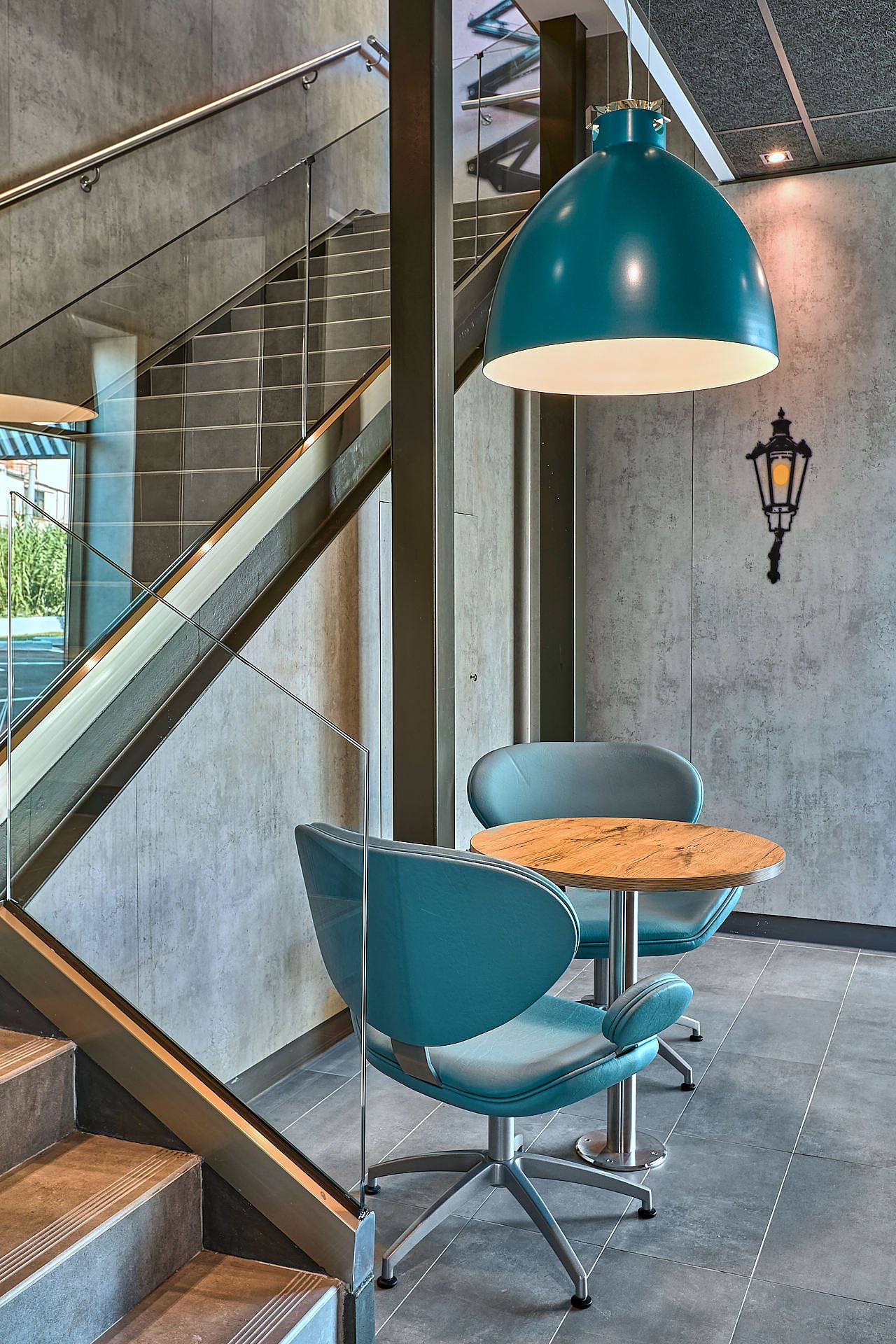 Modern McDonald’s interior with teal seating and pendant lighting
