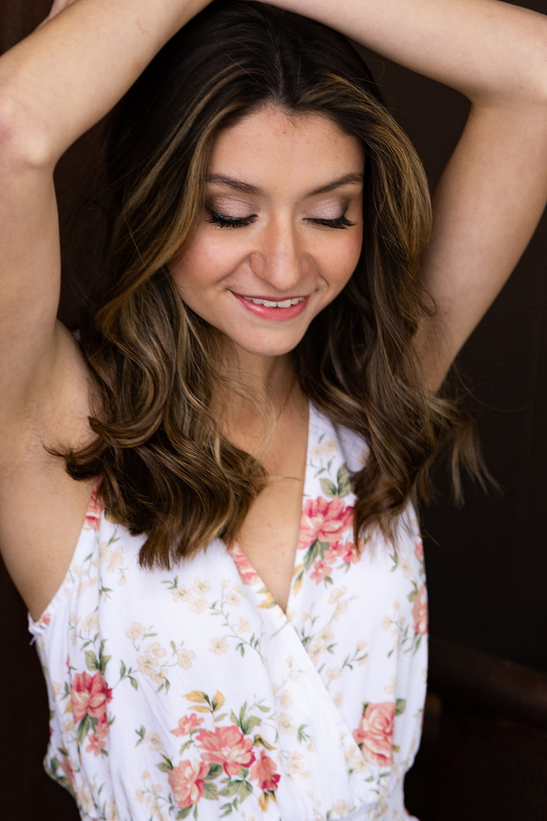 Senior portrait of girl with arms up