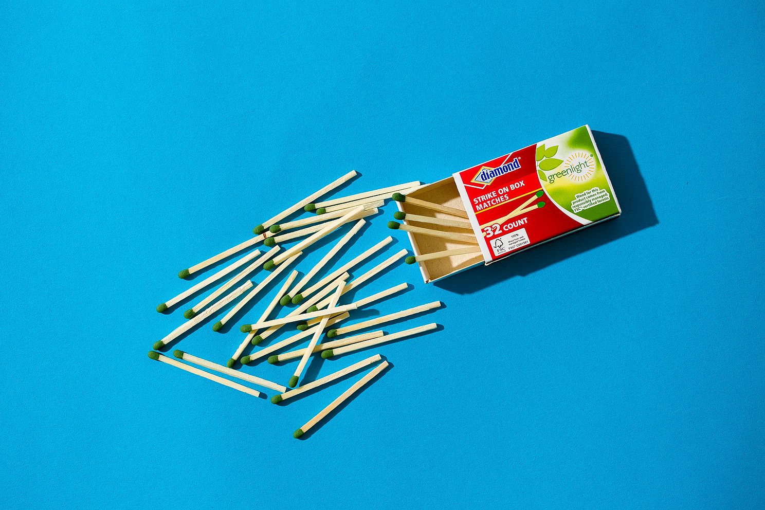 Scattered wood matches on blue background