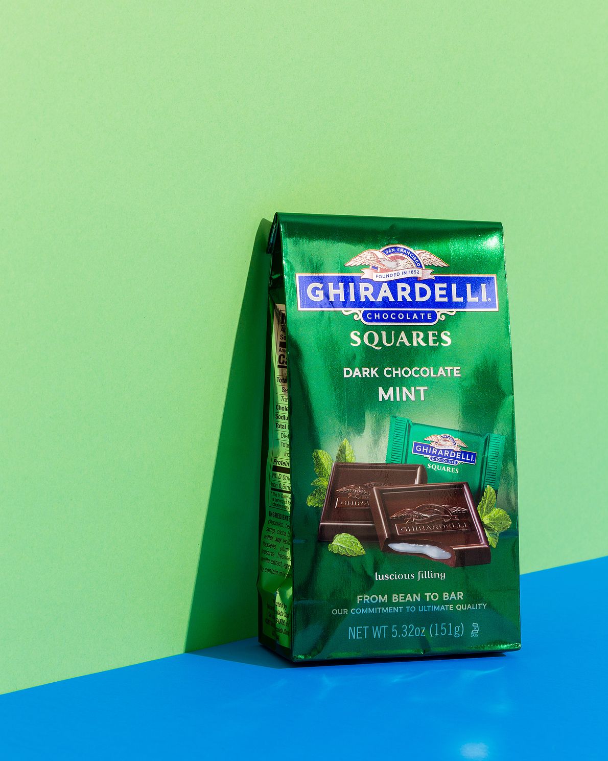 Ghirardelli dark chocolate captured on green and blue background