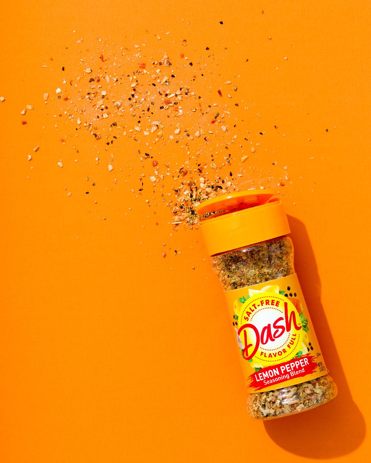 Dash lemon pepper seasoning captured on orange brand background