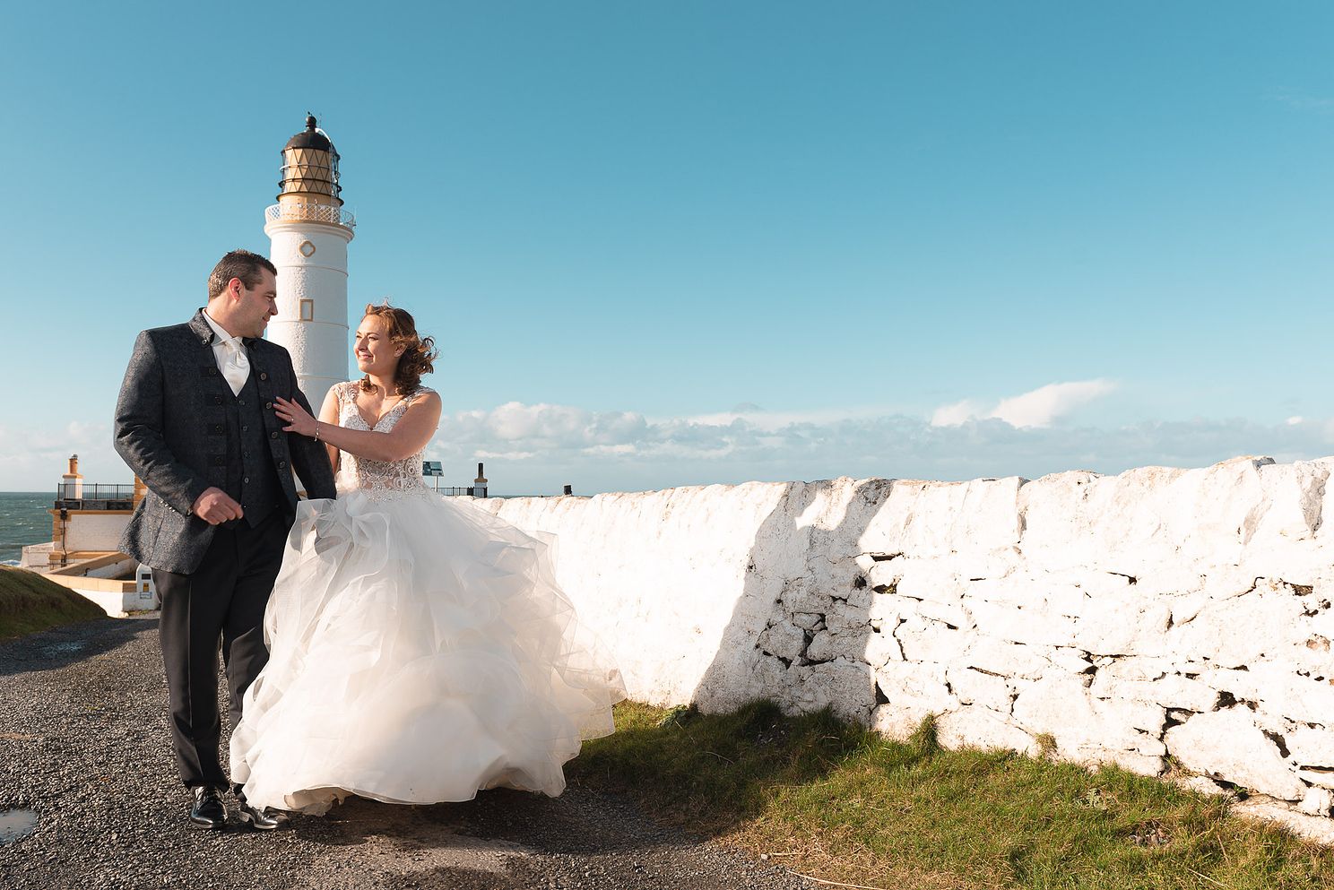 Newlyweds at Corsewall lighthouse by Stranraer wedding photographer based in Dumfries and Galloway.