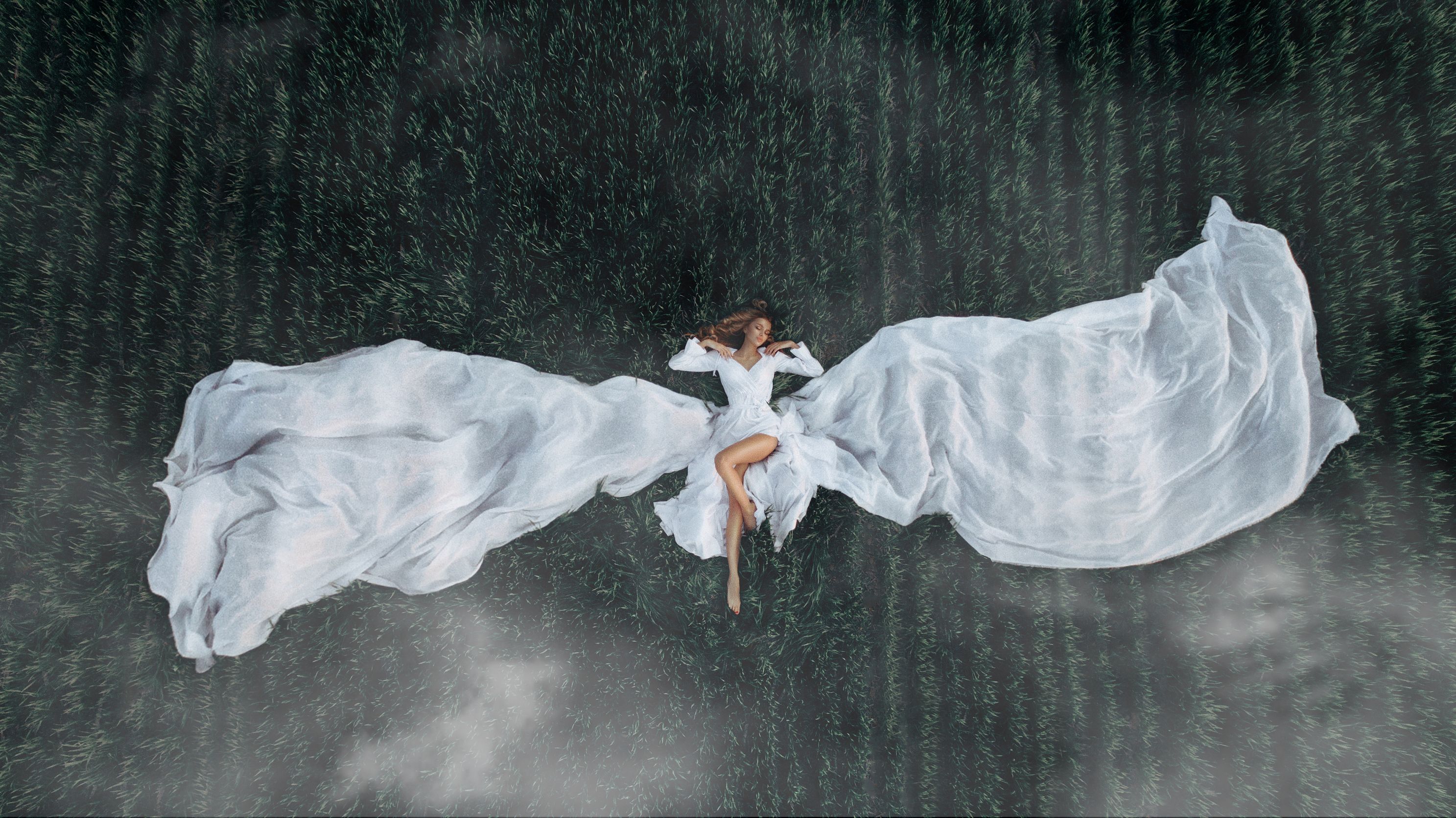 aerial-view-of-the-girl-that-lies-on-a-green-lawn-2025-01-09-00-35-12-utc.jpg