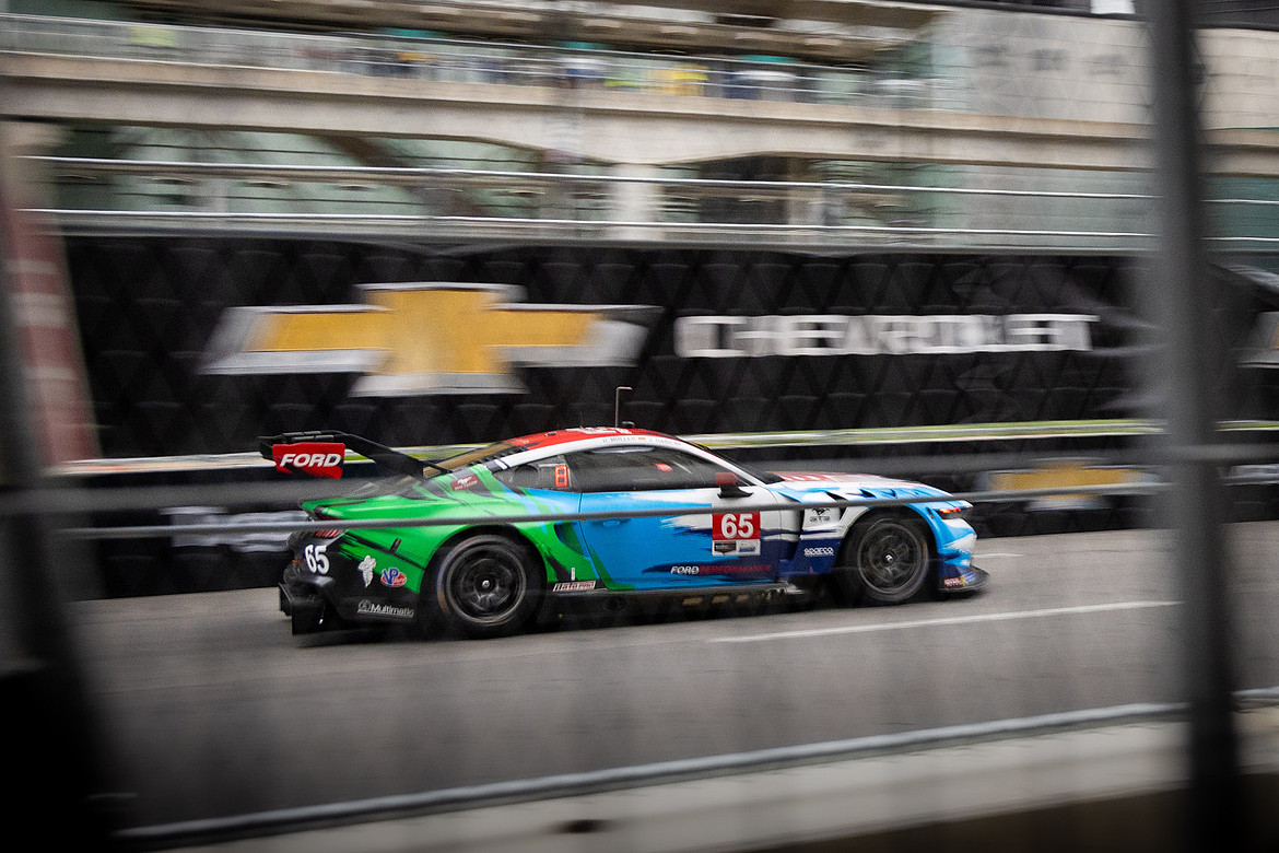 A race car rips past the Chevrolet logo at the 2024 Detroit Grand Prix