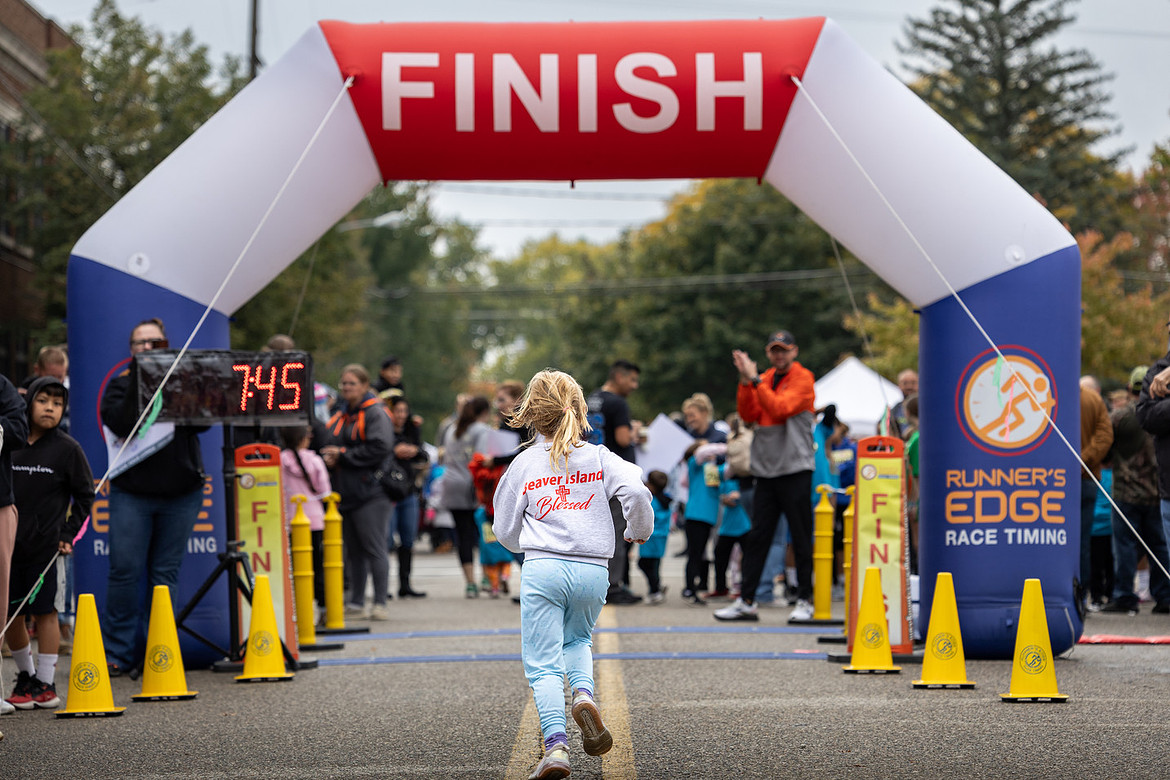 A runner finishes the Gosling Run at the 2024 Goose Festival in Fennville, Michigan