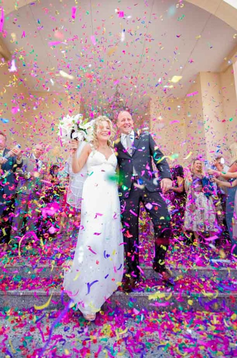 Confetti time for a groom and bride, photographed at her wedding in Swansea, South Wales