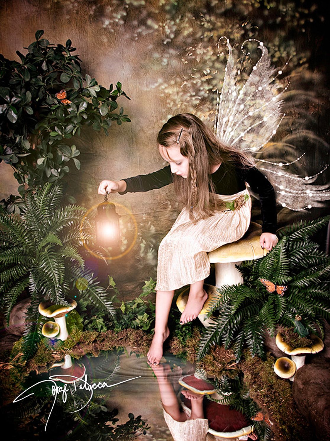 Enchanting fairy photoshoot featuring a child with delicate wings and glowing magical lights.