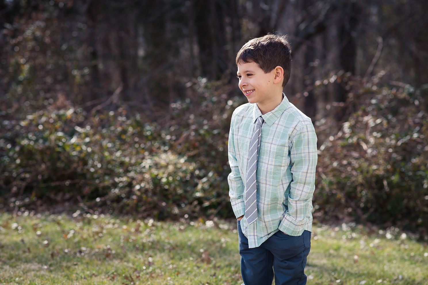 Boy wearing a tie laughing