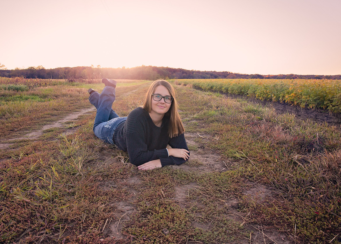 Senior girl in a field by Memories for Life Photography, LLC.