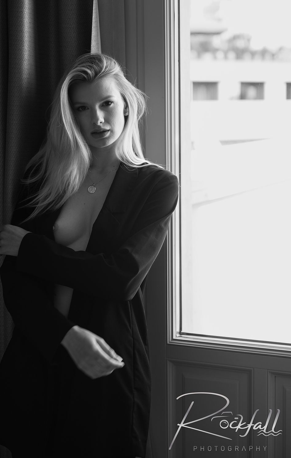 Boudoir image woman by window