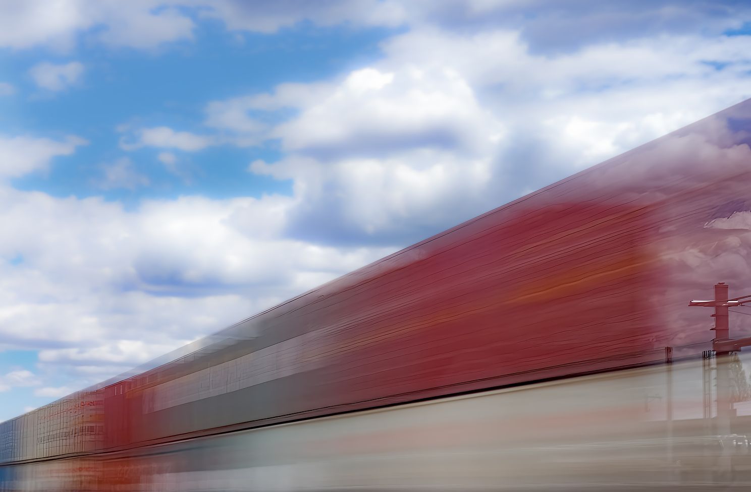 Long exposure of train speeding past Station, appearing to be transparent or outrun time