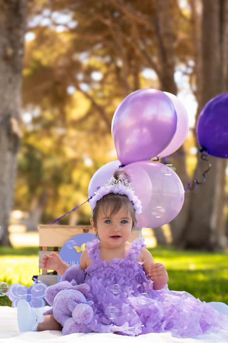 First birthday photoshoot in Perth at the park with purple balloons - Fyrefly Photography