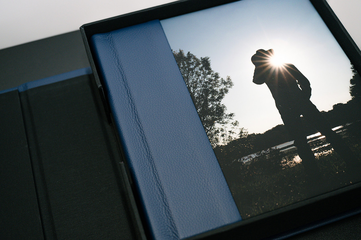 senior photo album with boy on the cover in a field wearing a cowboy hat