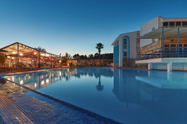 Outdoor swimming pool and hotel exterior at Skion Palace in Halkidiki
