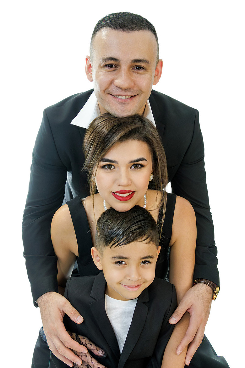 Elegant family portrait with parents and child in black attire, captured by ONE NINE SIX NINE Photo
