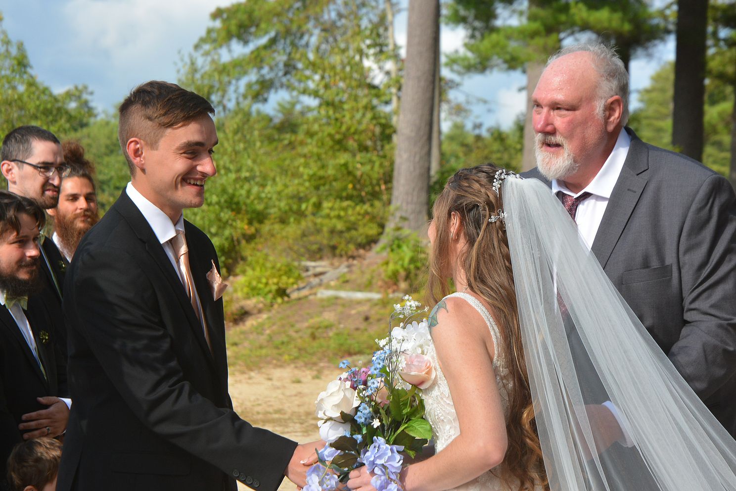 DSCjpg Bride's dad gives her away to groom in the beginning of wedding ceremony outdoors by lake