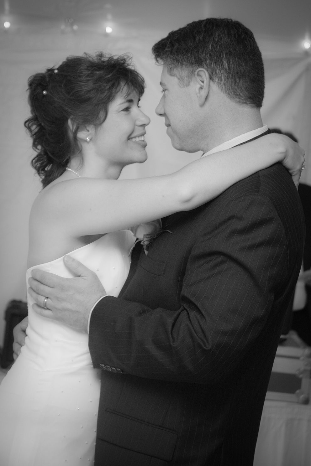 DSCjpg Bride and groom share a candid moment on dance floor celebrating their first dance together