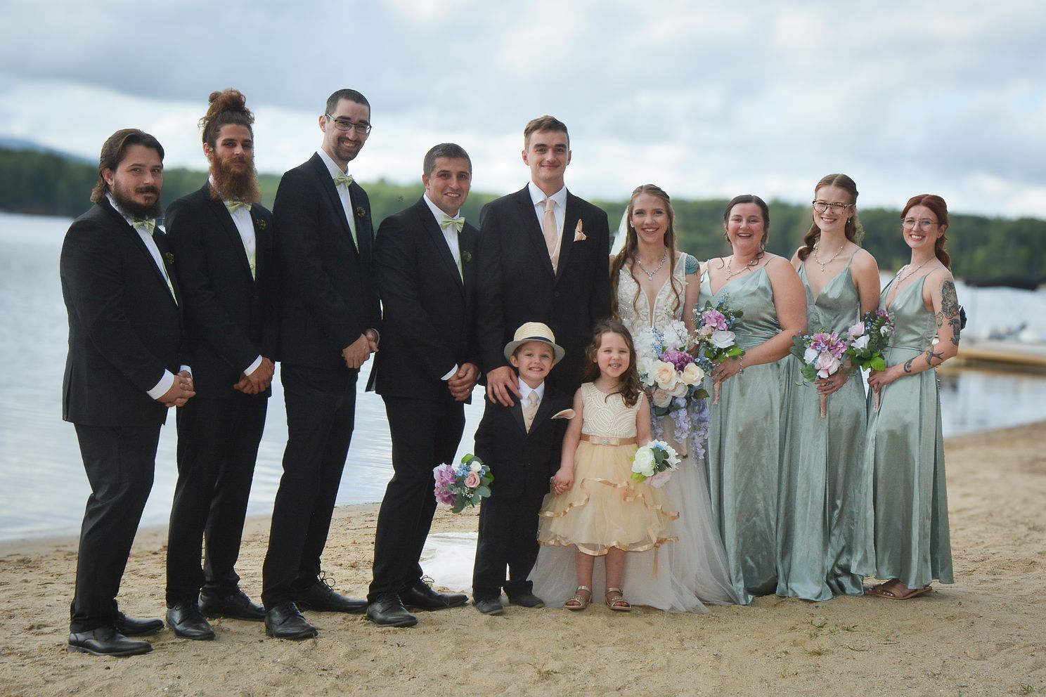 DSCjpg Bridal party poses for formal image with children in full length shot on the shore of a lake