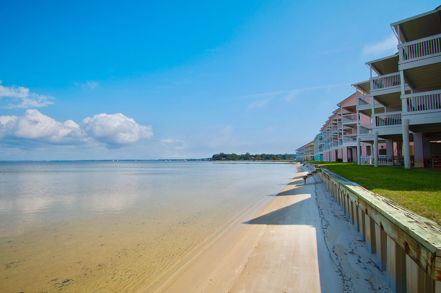 View of a quiet, sandy beach at a townhome property