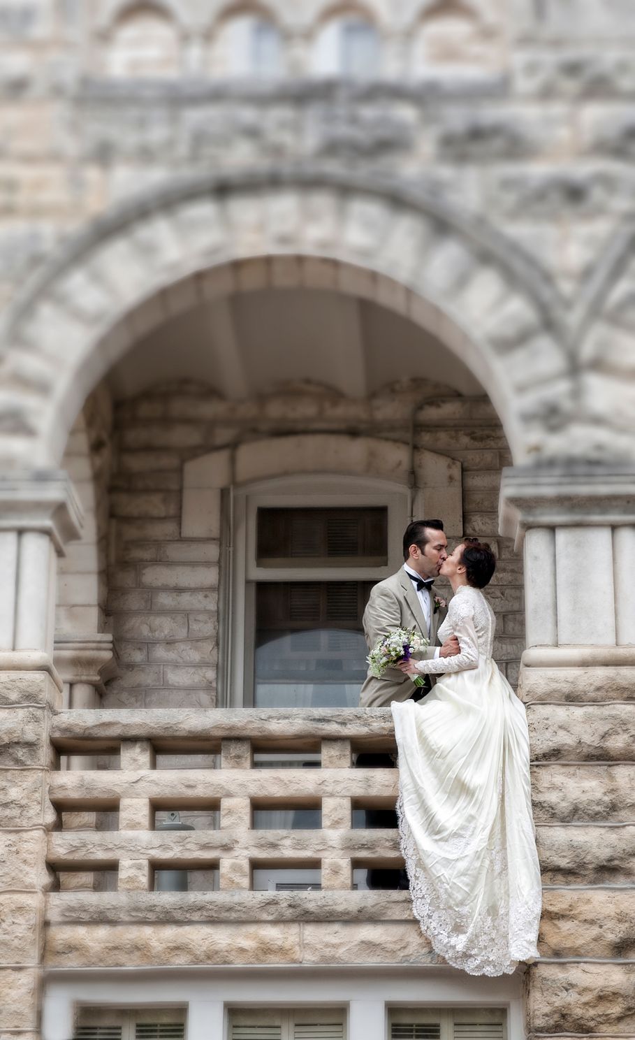 wedding photo in the Austin, TX area. Man and wife standing at a stone building