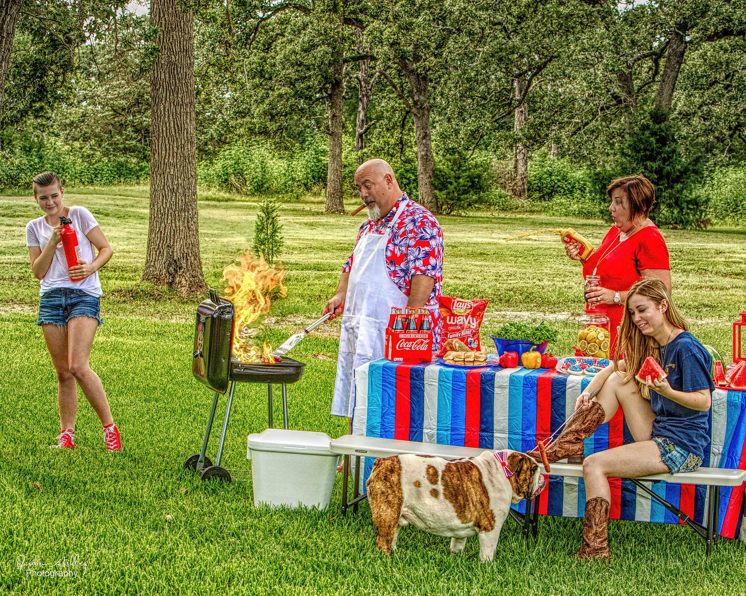 candid family portrait showing a family grilling in the park in Cedar Park, Texas