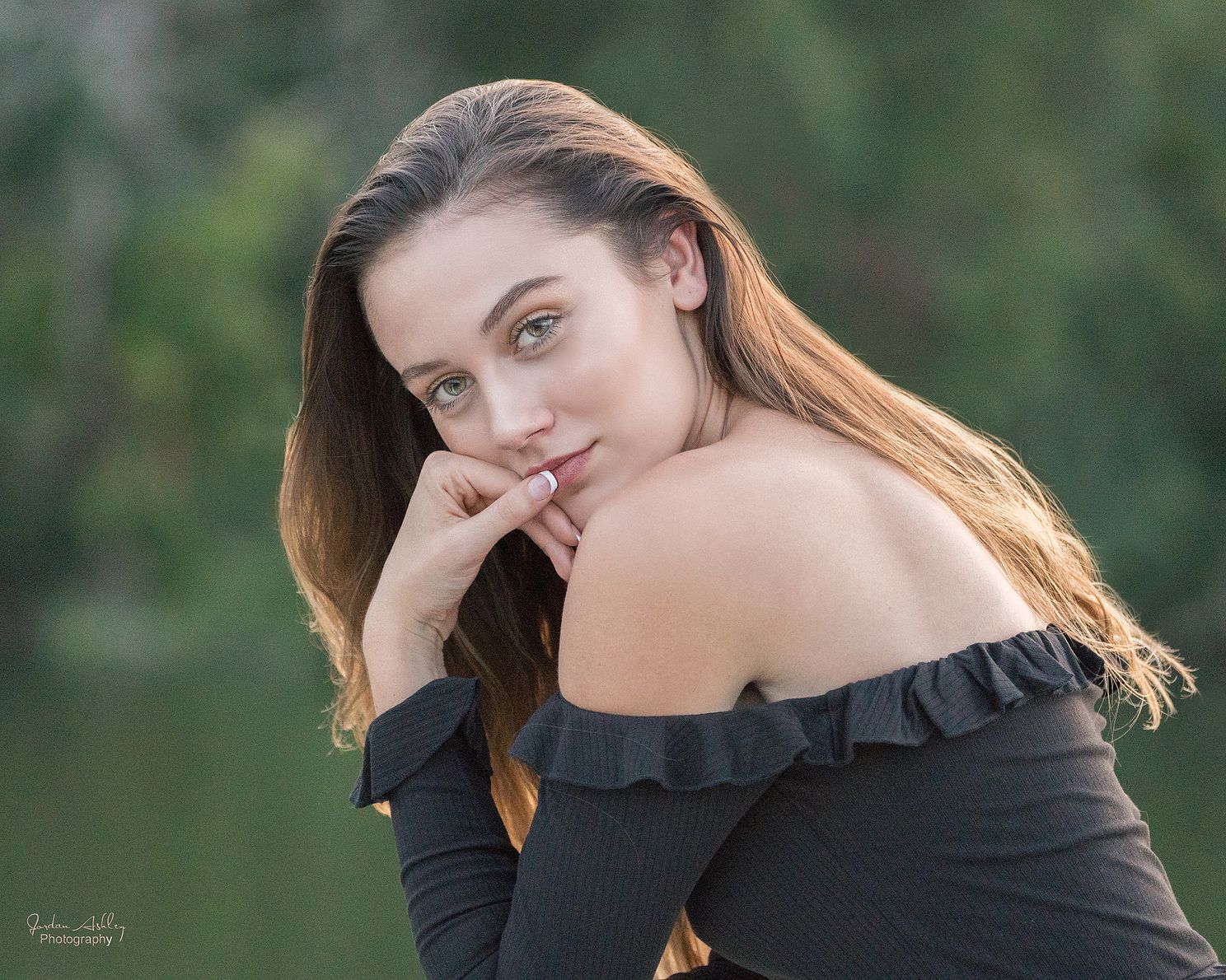 Senior portrait of high school girl with brown hair and black top