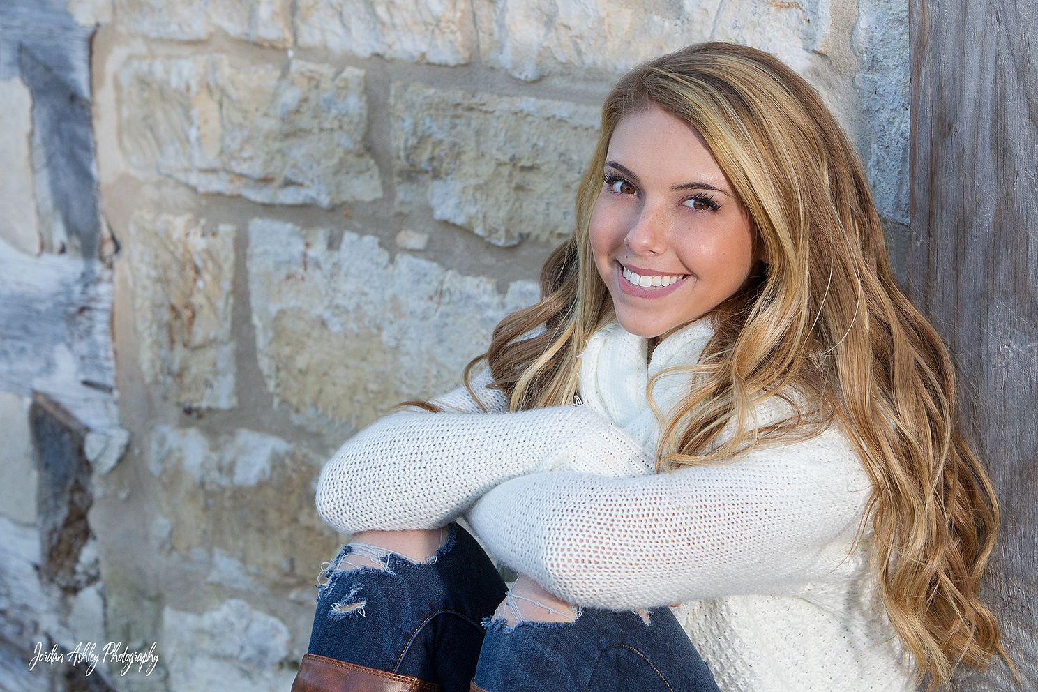 senior photo of girl with arms crossed taken in Austin TX