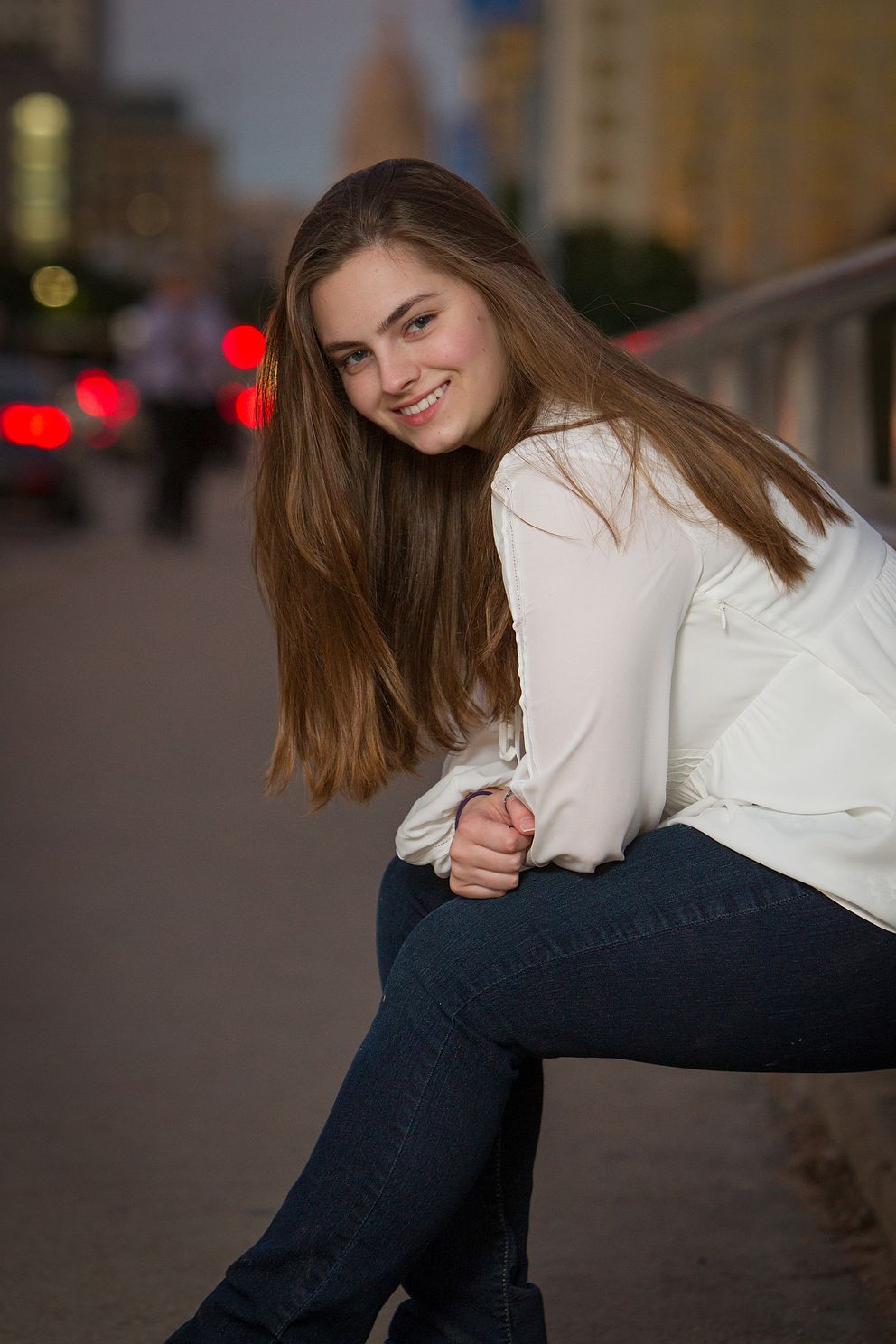 senior girl sitting on the curb near Austin, TX