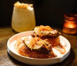 shredded kobe beef over crispy rice patty topped with pickled vegetables drizzled with yum yum sauce