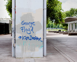 Graffiti spray painted on a wall stating I Cant Breathe George Floyd
