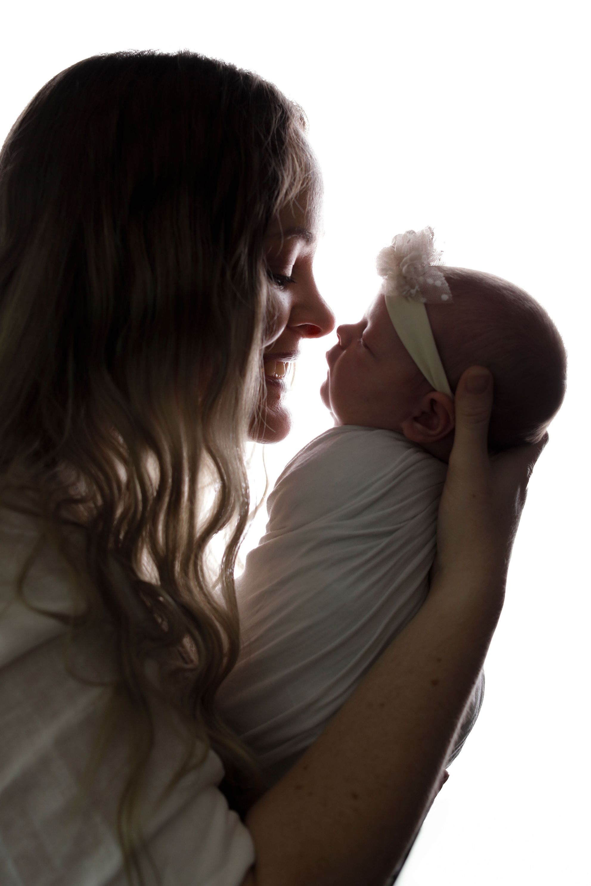 Mother and daughter silhouette image, newborn baby 14 days old baby girl, in home studio accredited