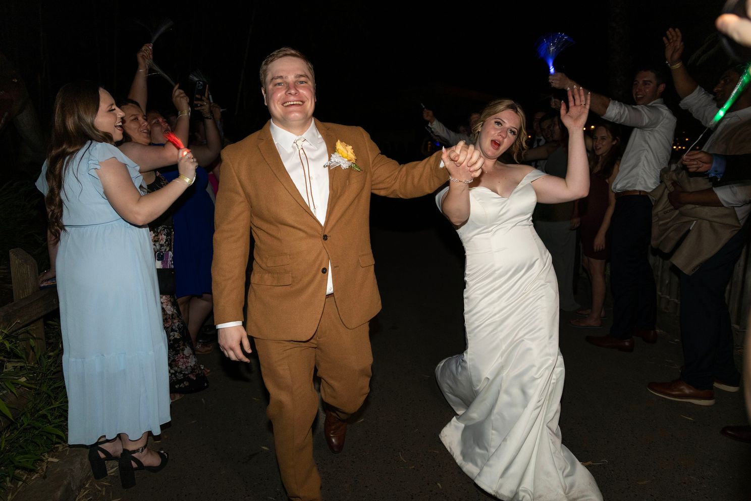 Shelby and John leaving the Sacramento Zoo wedding dancing through the exit with the guests.