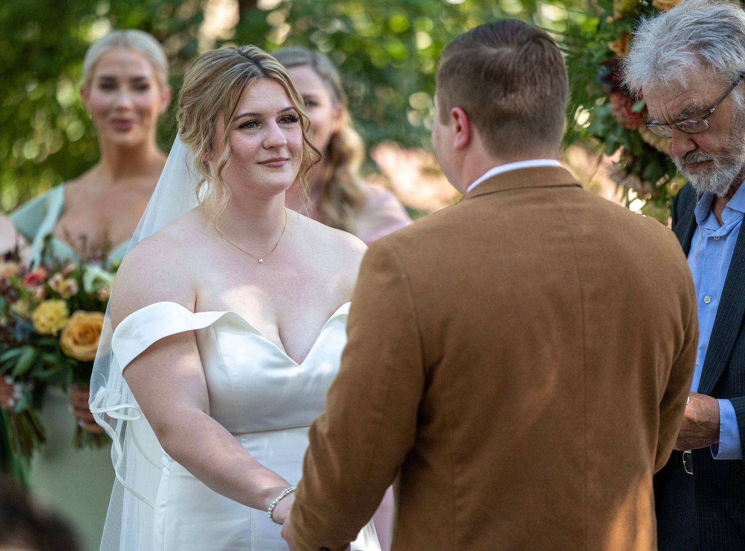 Shelby and John holding hands during ceremony of their Sacramento Zoo Wedding.