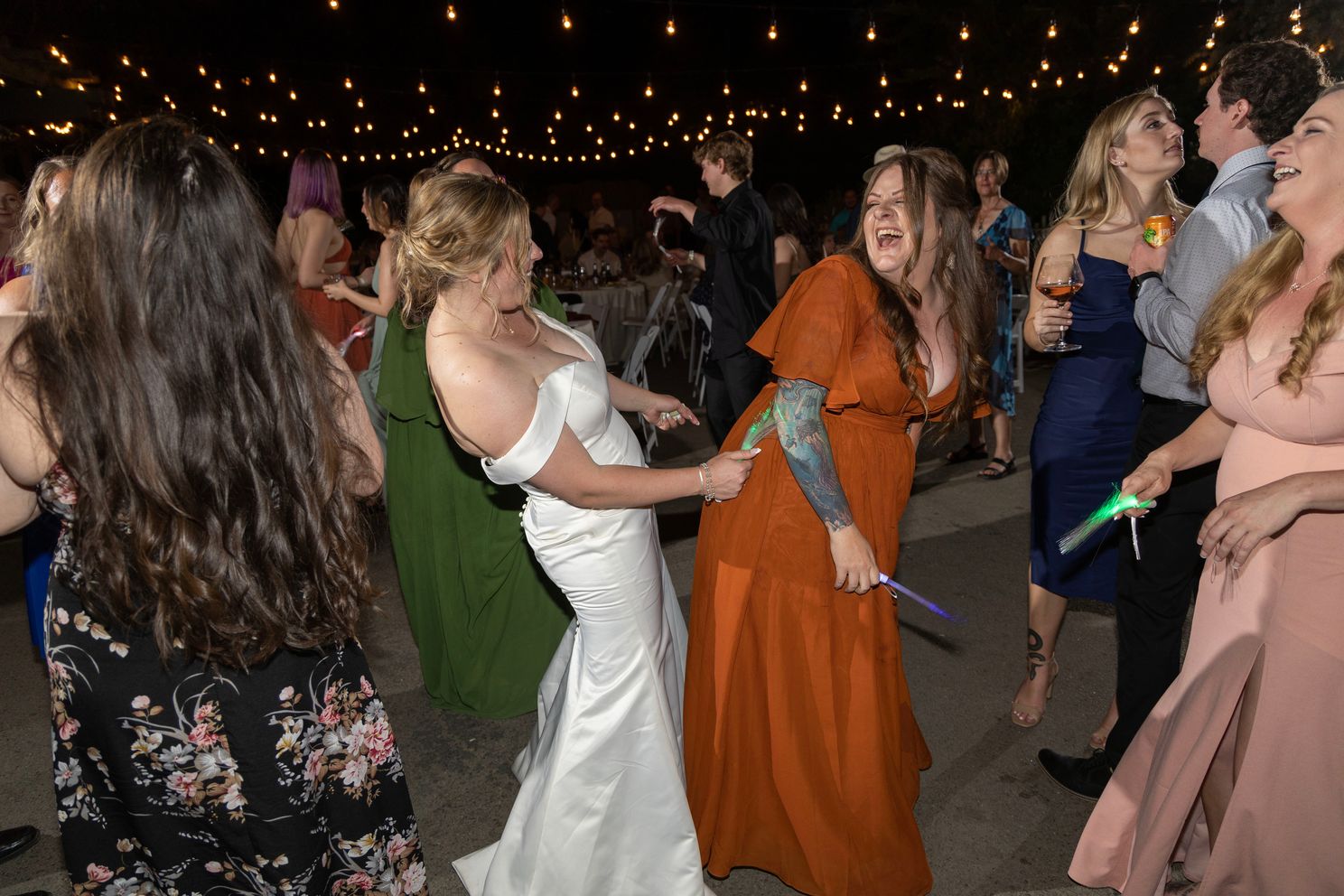 Wedding at Sacramento Zoo. Bride and Maid Oh Honor (MOH) dancing while drinking at the reception.